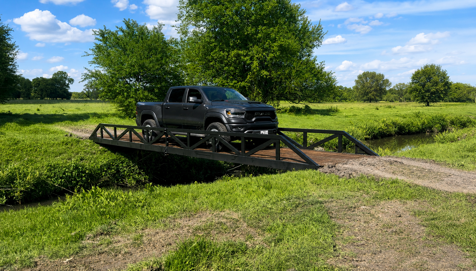 Warren truss vehicle bridge with painted finish over a creek.